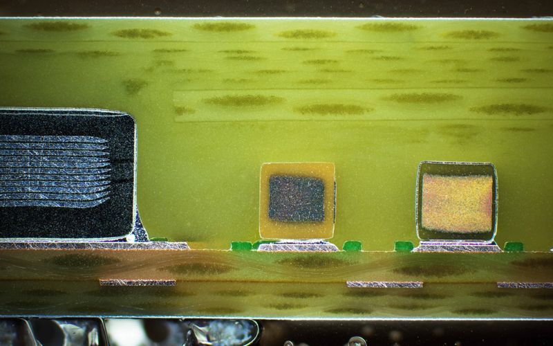 Detailed view of an embedded component contacted by the pad bonding process.